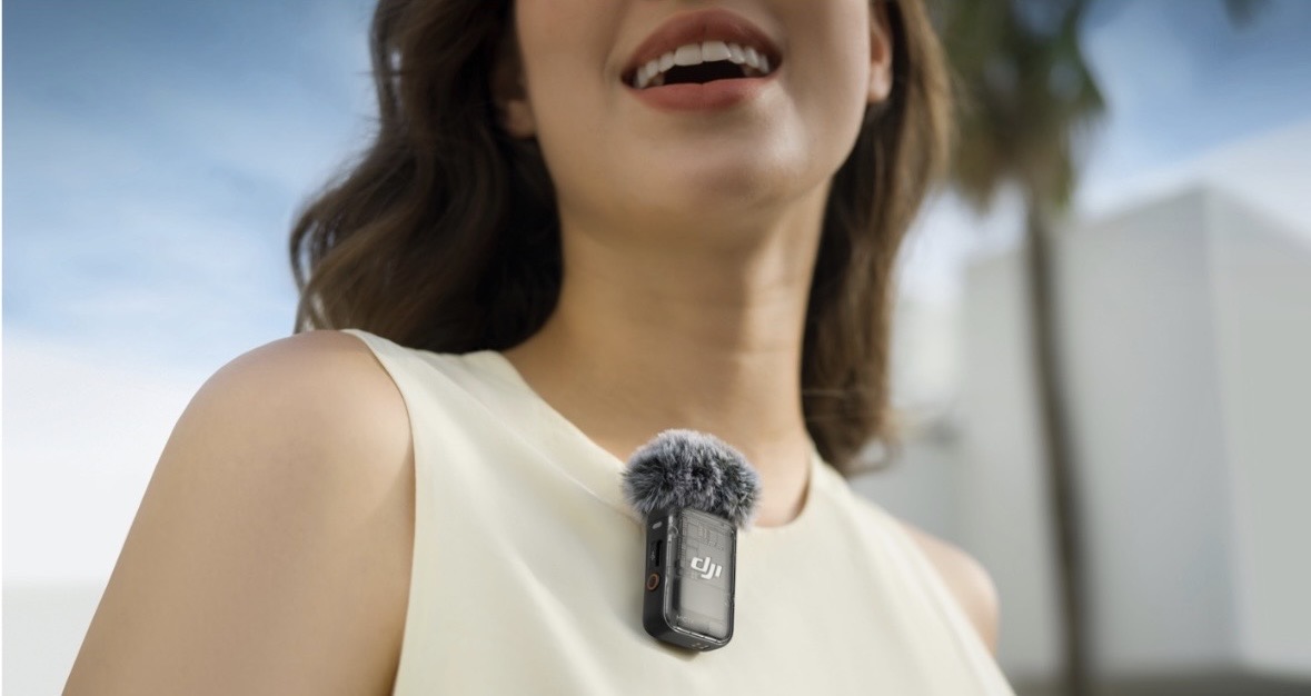 A wearable clip-on microphone capturing an in-person conversation for the Agentic Note Taker
